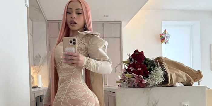 Cropped view of Ice Spice snapping a selfie of her backside