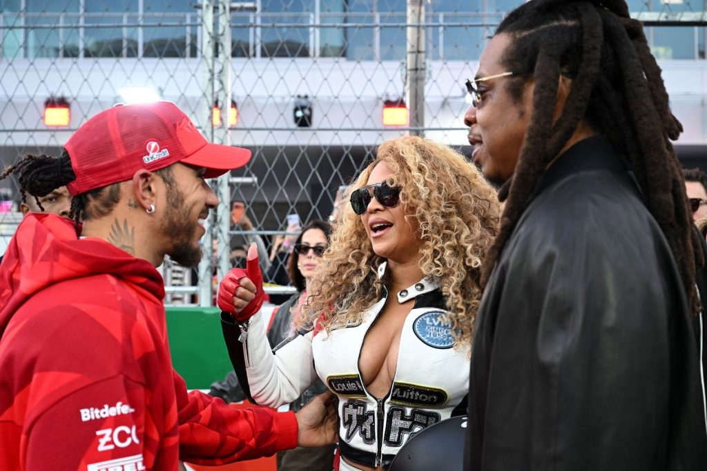 Close up of Beyonce and Jay-Z talking to Lewis Hamilton