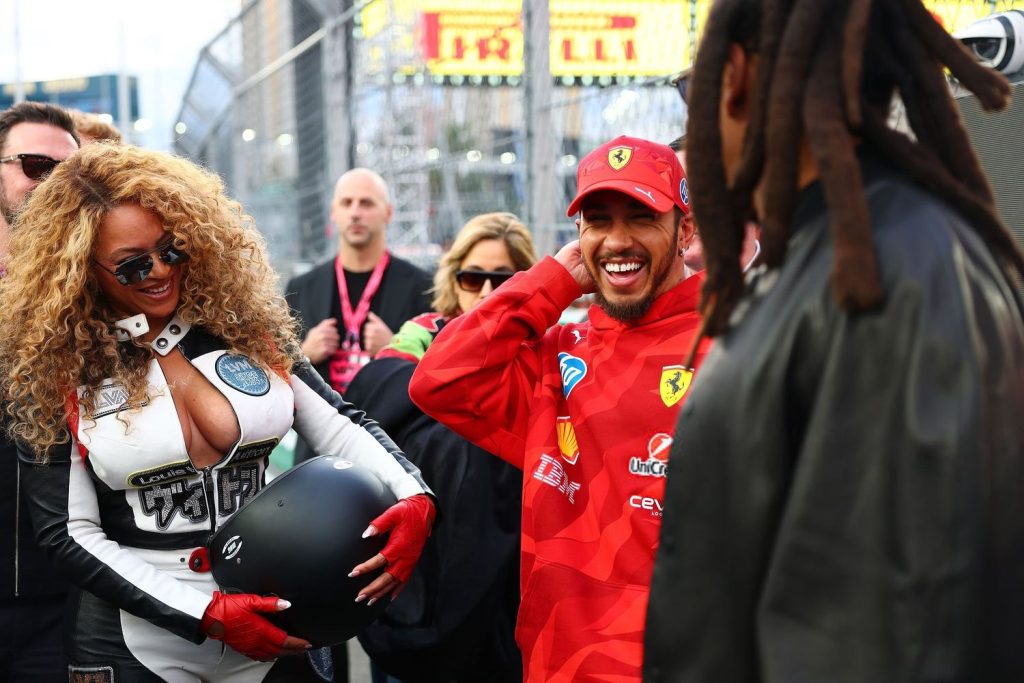 Close up of Beyonce, Jay-Z and Lewis Hamilton sharing a laugh