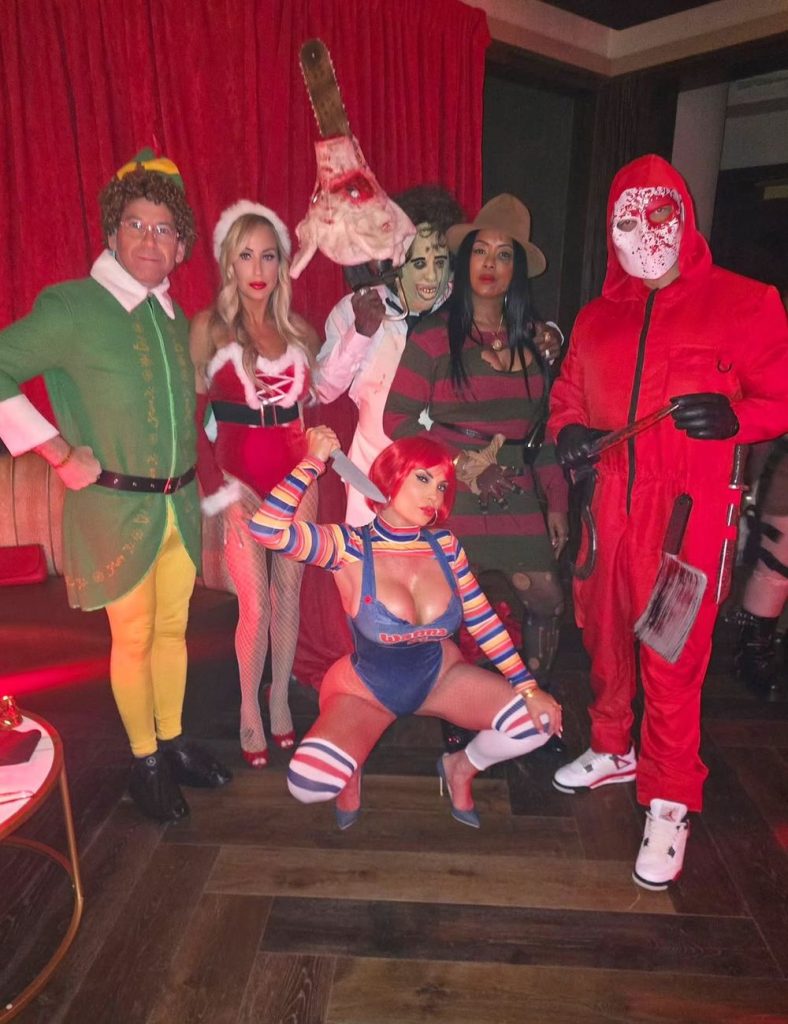 Far away view of a group of people posing in Halloween costumes