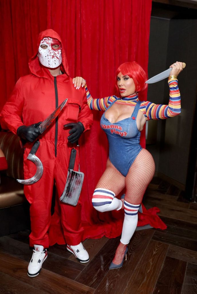 Full body front view of  woman and man posing in Halloween costumes