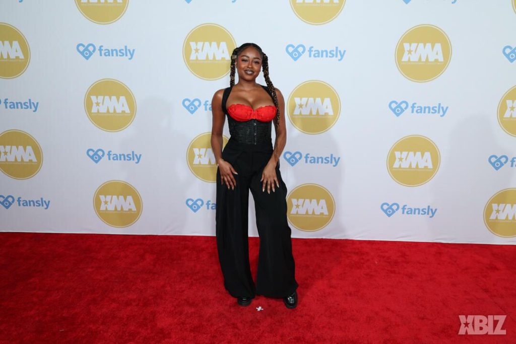Full body frontal of ebony porn star posing on the red carpet