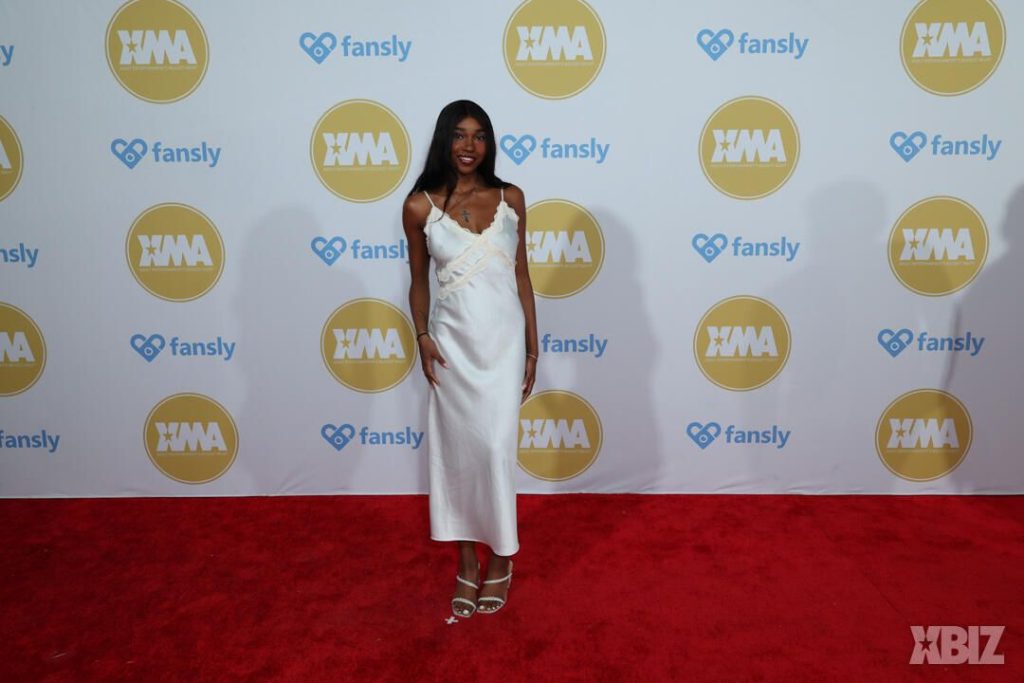 Full body frontal of ebony porn star posing on the red carpet