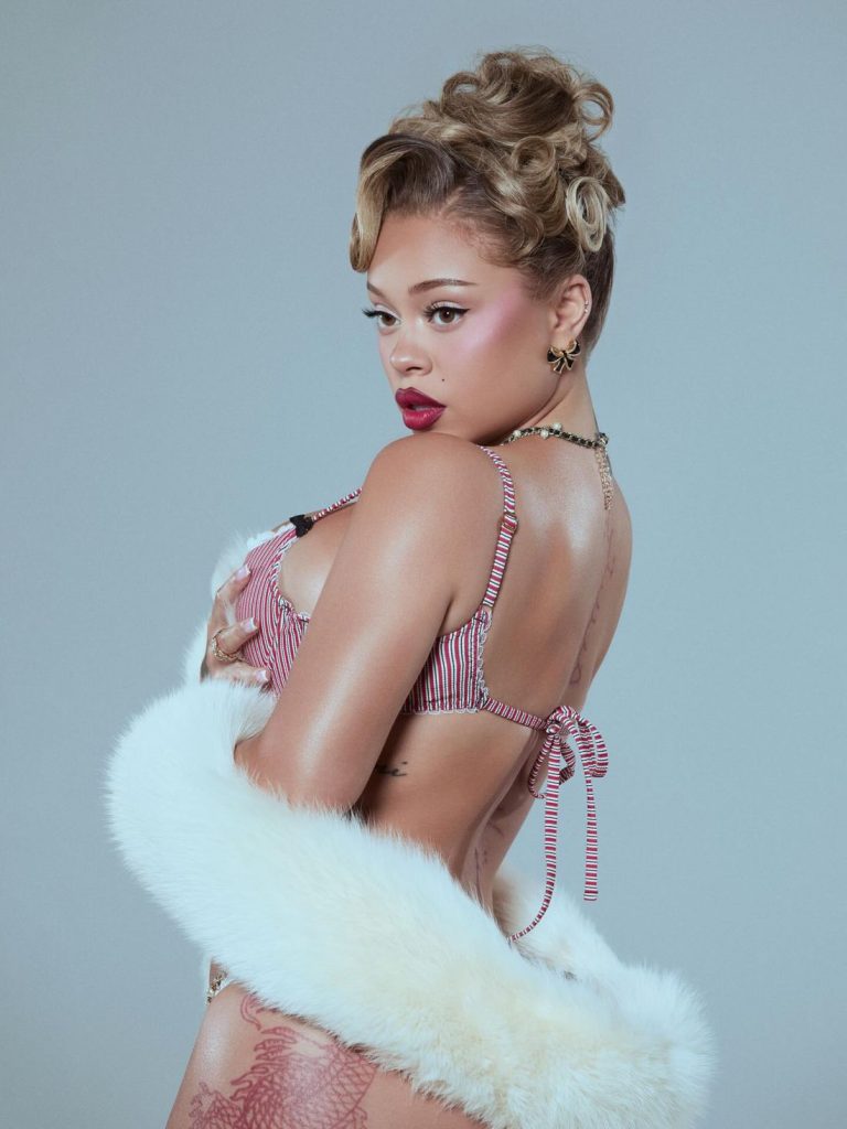 Close up up side view of Latto in a bra and turning her head