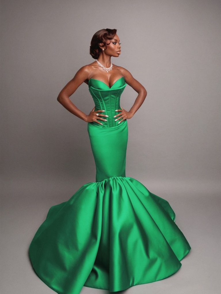 Full body frontal of black woman posing with her head turned