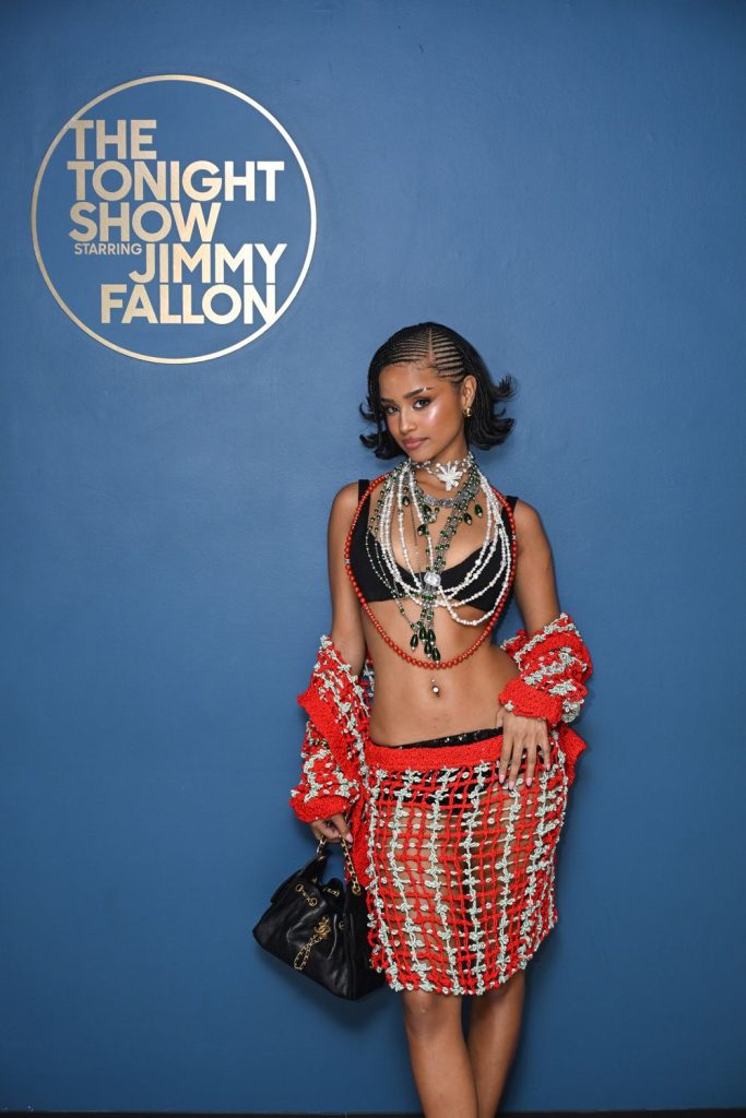 Frontal of Tyla posing in front of a plain background with the words The Tonight Show With Jimmy Fallon written in the top left corner