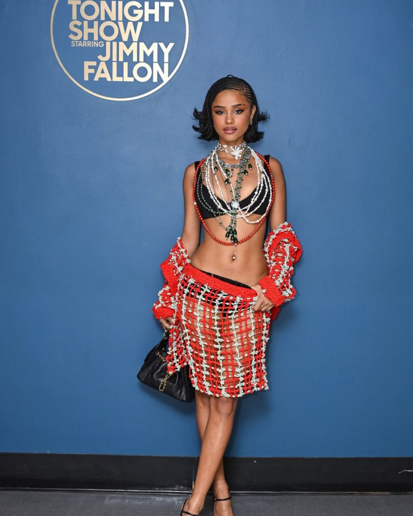 Full body frontal of Tyla posing in front of a plain background with the words The Tonight Show With Jimmy Fallon written