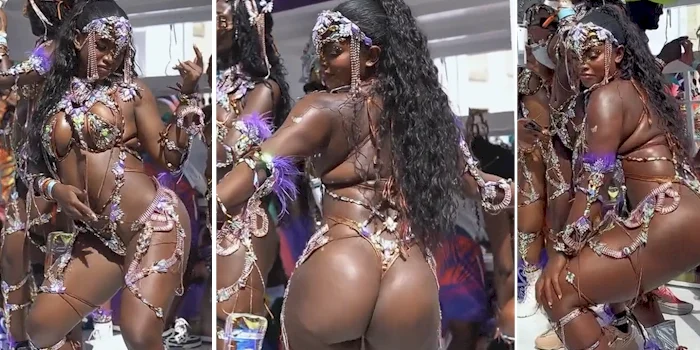 A thick woman dancing and wearing a colorful carnival costume