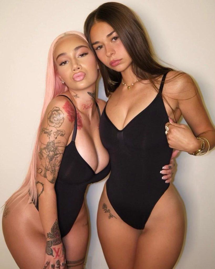 Two women in black swimsuits posing