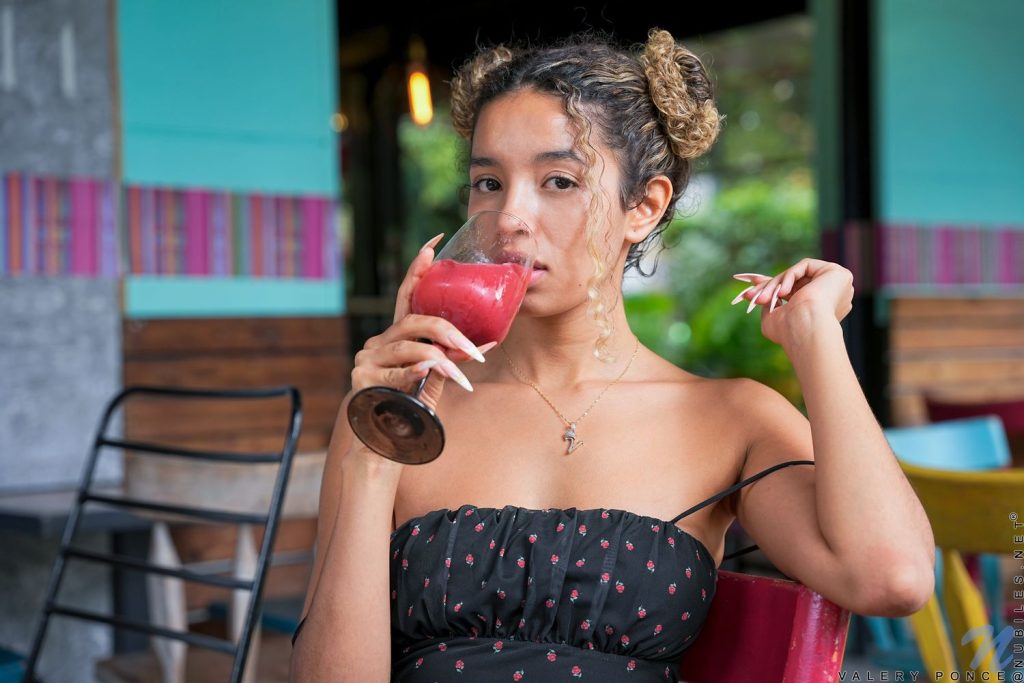 Close up of young woman enjoying a drink