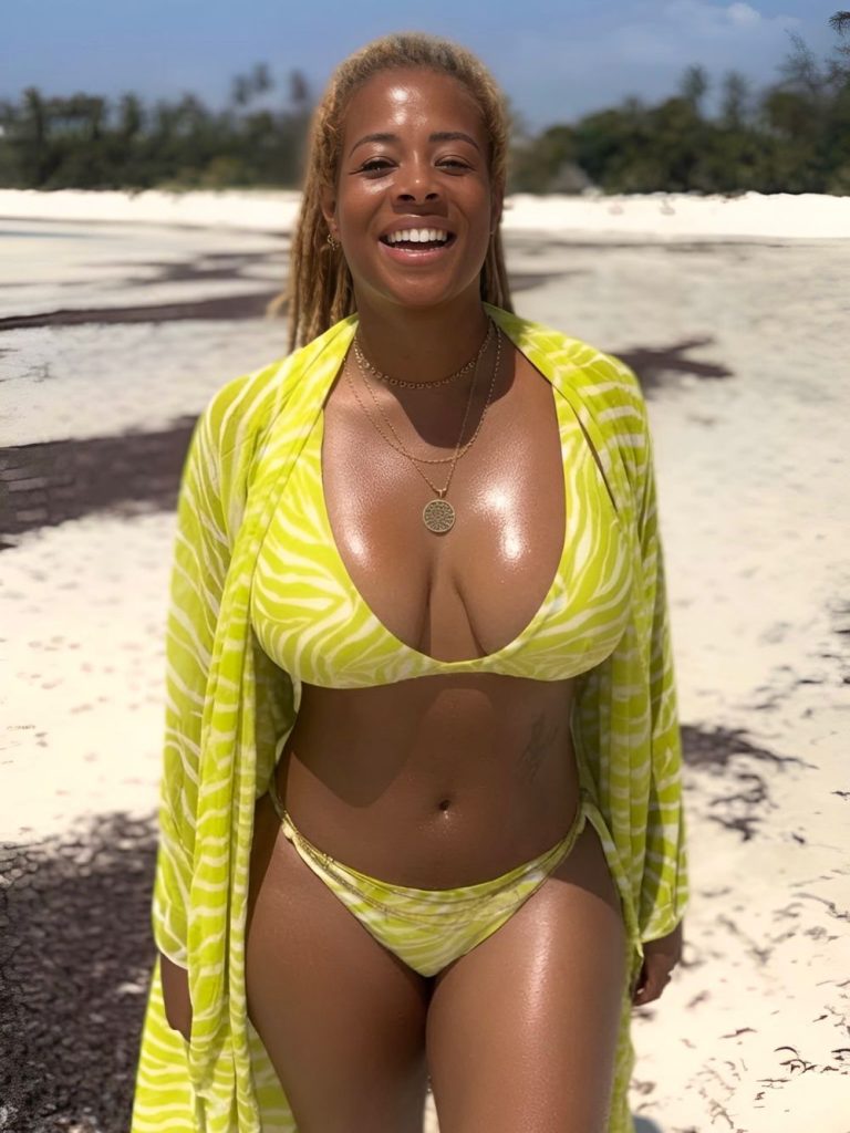 A woman in a yellow patterned bikini and matching cover-up smiles on a sunny beach with trees in the background.