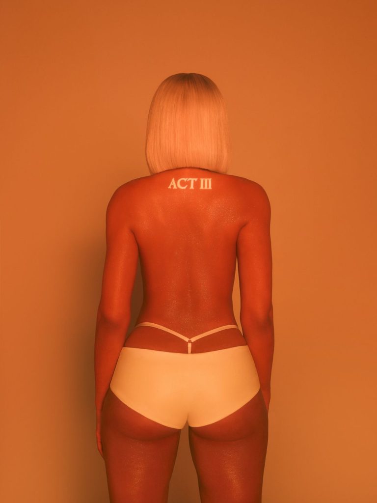 A woman with short blonde hair, seen from behind, wears light underwear. ACT III is written on their upper back. The image has an orange tint.